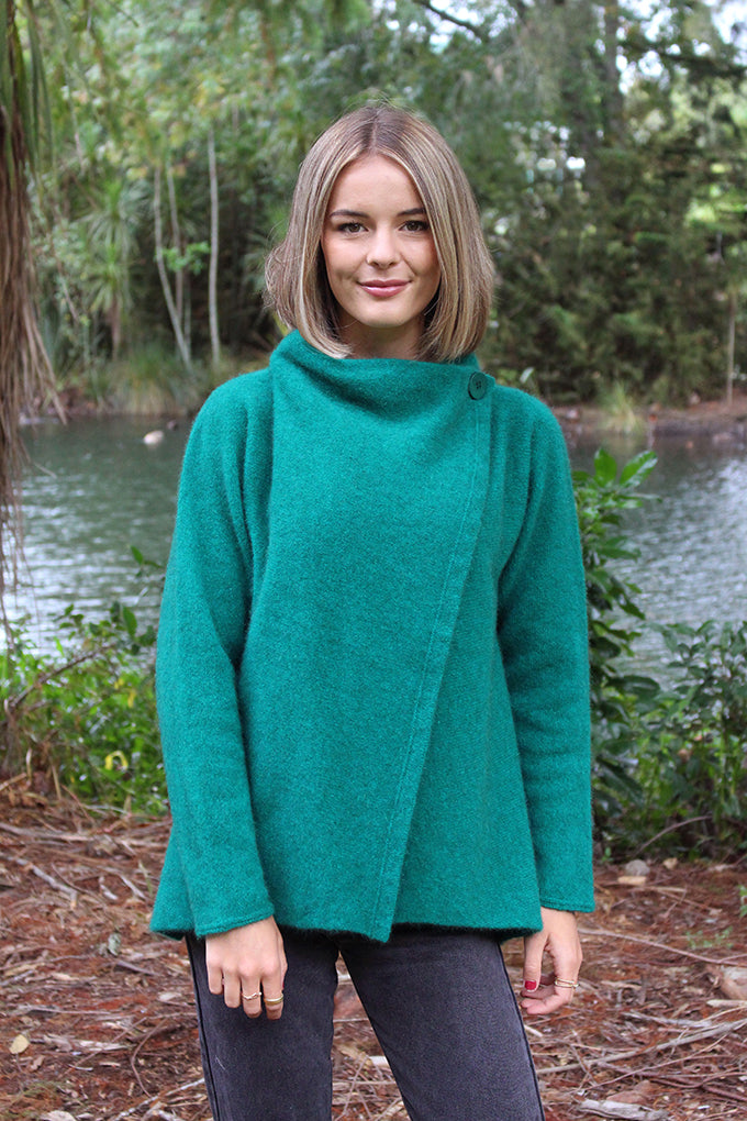 This stylish jacket fastens with a cross over front that buttons either side at shoulder or leave unbuttoned to fall in a waterfall drape.
