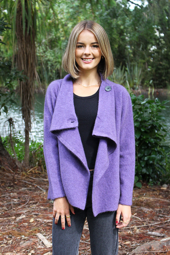 This stylish jacket fastens with a cross over front that buttons either side at shoulder or leave unbuttoned to fall in a waterfall drape.