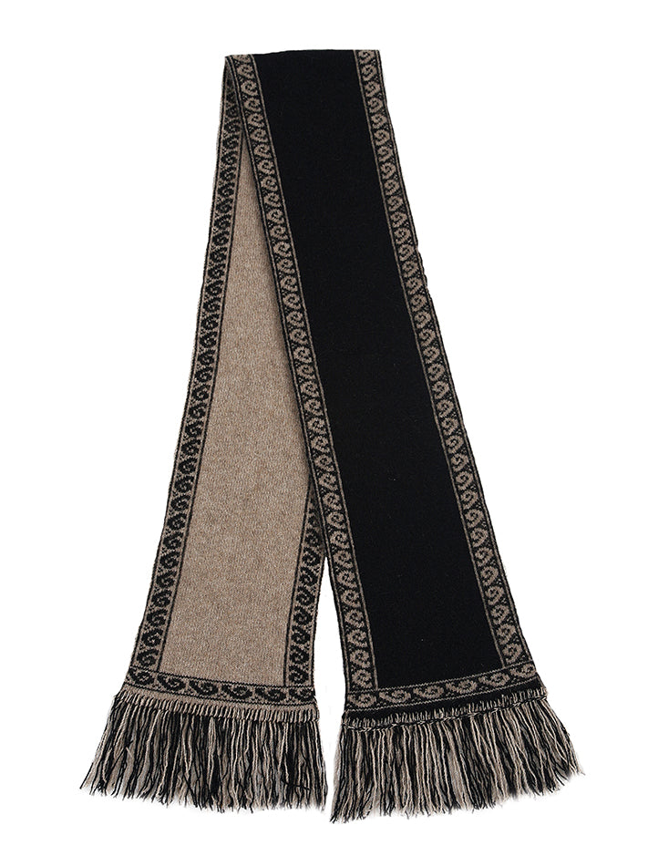 A unisex scarf knitted in double thickness with a koru patterned edging. A long scarf that is reversible and has two tone fringing. Approx. 19cm x 154cm long with 7cm fringe. Made in NZ by Lothlorian. Natural.