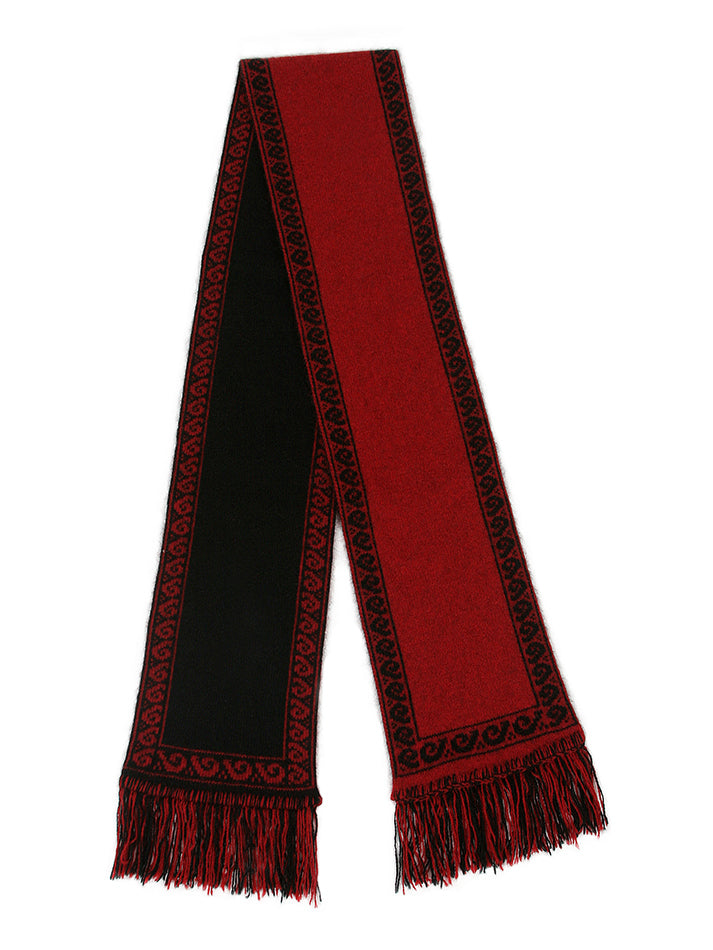 A unisex scarf knitted in double thickness with a koru patterned edging. A long scarf that is reversible and has two tone fringing. Approx. 19cm x 154cm long with 7cm fringe. Made in NZ by Lothlorian. Red.