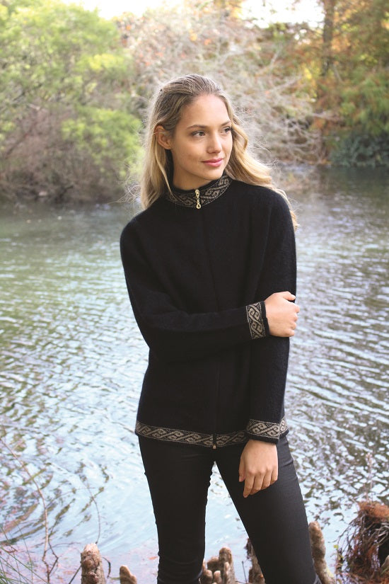 A zip through cardigan with a motif pattern on collar, cuffs & hem in a contrasting colour.  A possum merino blend available in sizes XS-XXL. Made in NZ by Lothlorian. NOTE: * after colour denotes a custom colour to our store, not always readily available. Black.