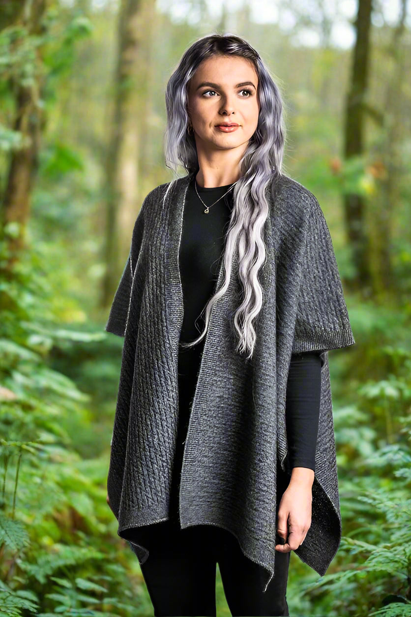 A great "throw on and go" piece to add to your collection. This fabulous cape has a small seam to form a loose and practical arm hole. In a detailed zig zag pattern, you can dress this cape up or down to suit any occasion. Made in Warkworth, NZ by Koru Knitwear. Grey.