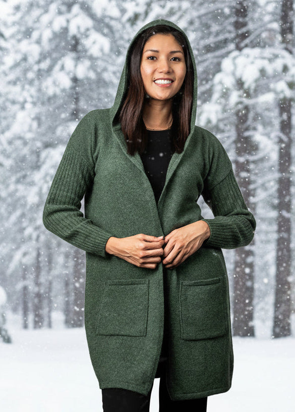 This beautiful classic longline cardigan features ribbed sleeves, patch pockets and hood. Made from a luxurious blend of Possum, Merino and Silk you will want to wear it all winter long! Made in NZ by Koru for their Trilogy Collection.
