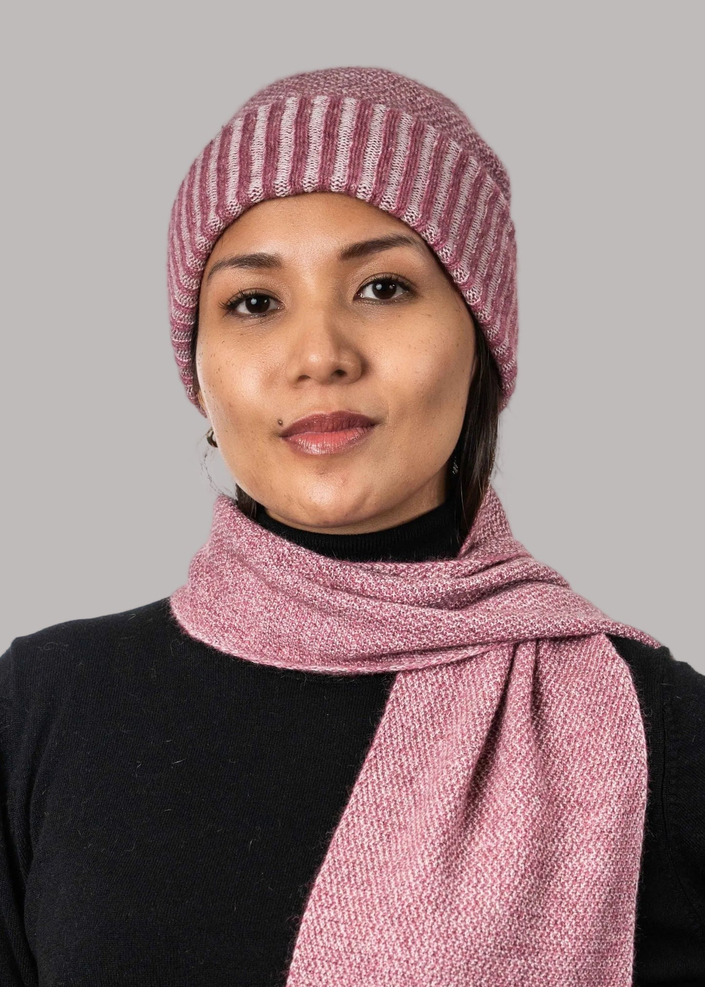 A versatile lightweight beanie knitted in a textured moss stitch pattern. This beanie is created with a yarn plating technique to create a subtle two tone effect. One size only. Made by Koru Knitwear NZ.