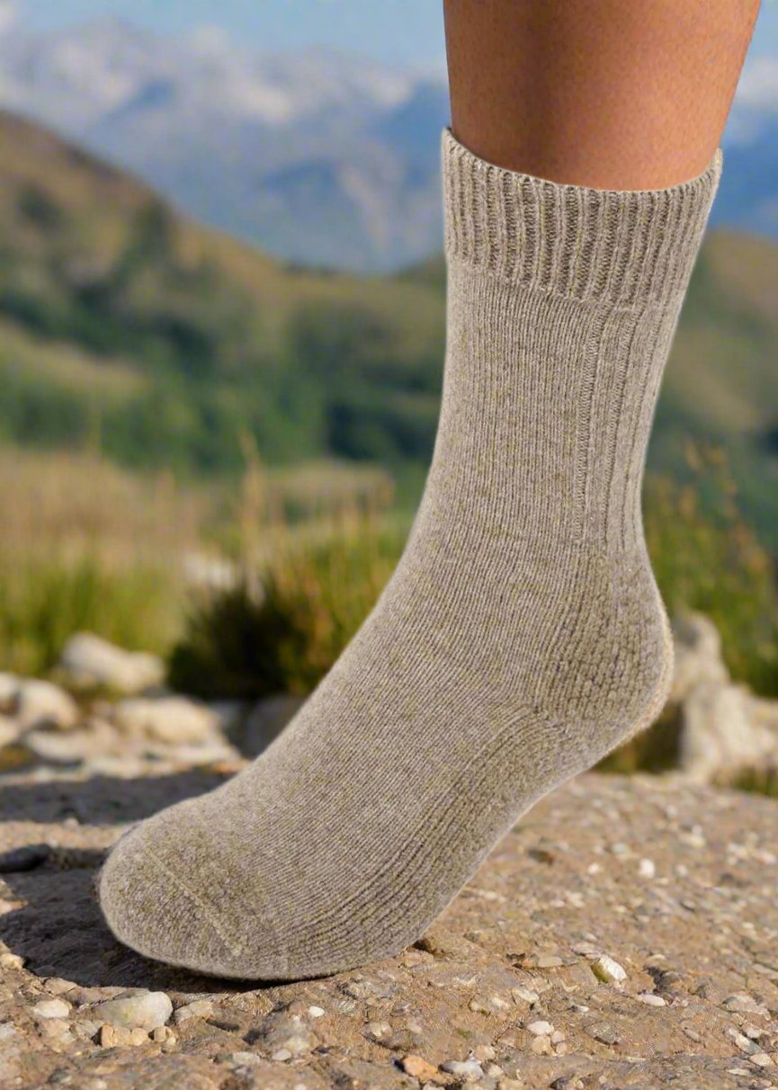 A ribbed mid-calf length sock that has a cushioned sole for extra comfort. In sizes S, M, L & XL. Made in NZ by Lothlorian. natural