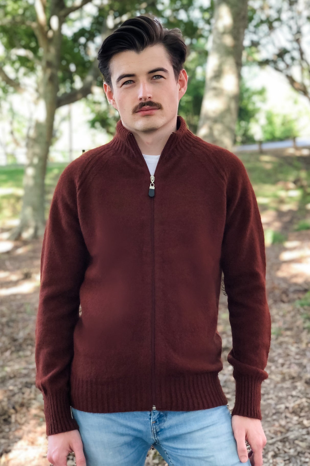 A classic Men's full zip raglan sleeve jacket with feature elbow stitch detail. A possum merino blend jacket available up to a size 3XL. Made in NZ by Lothlorian. Russet.