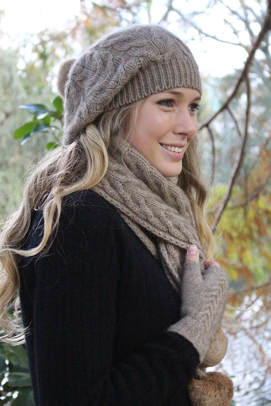 A relaxed cable beanie with rabbit fur pom pom. Colour - Natural with natural pom pom.