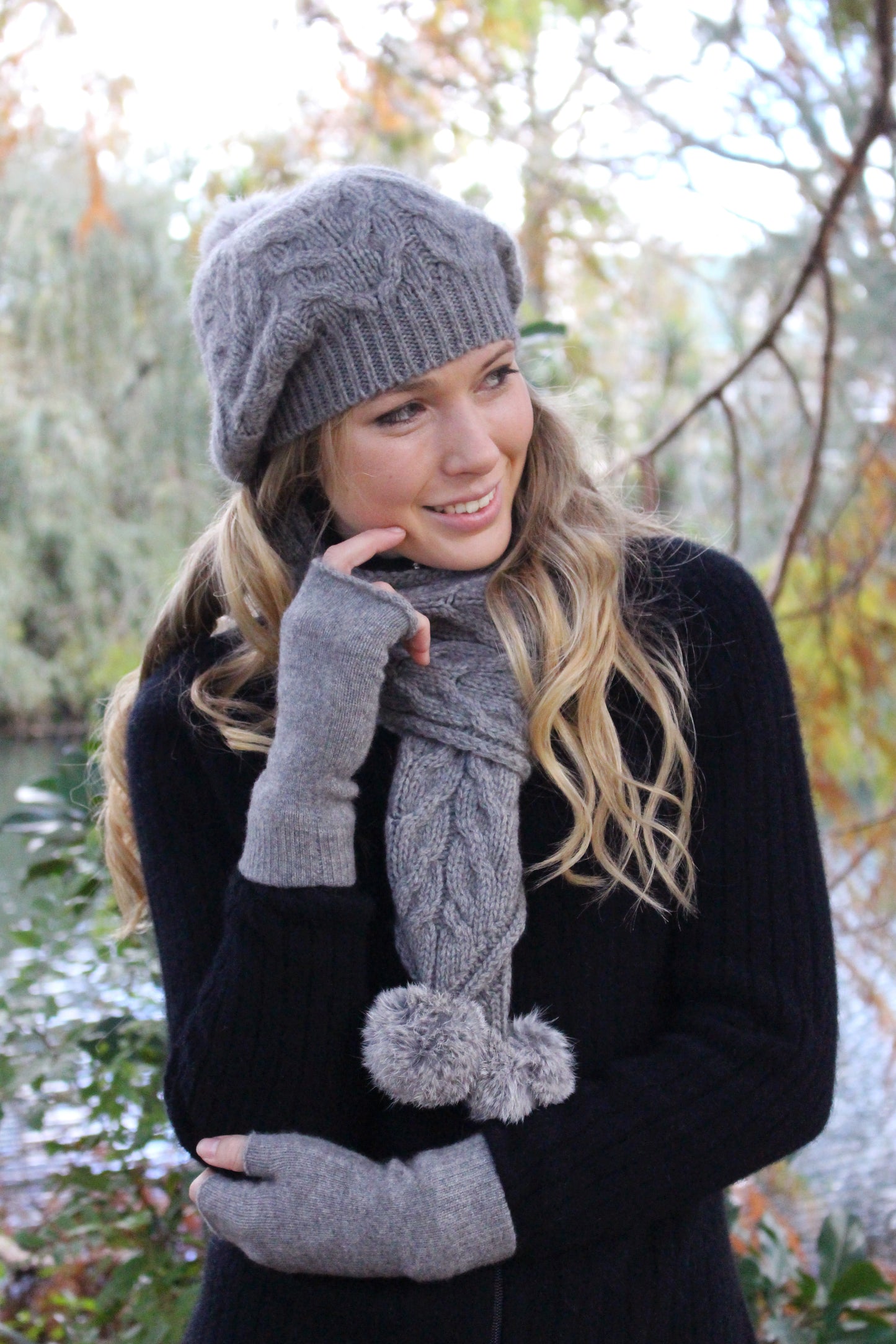 A relaxed cable beanie with rabbit fur pom pom. Colour - Silver with grey pom pom.