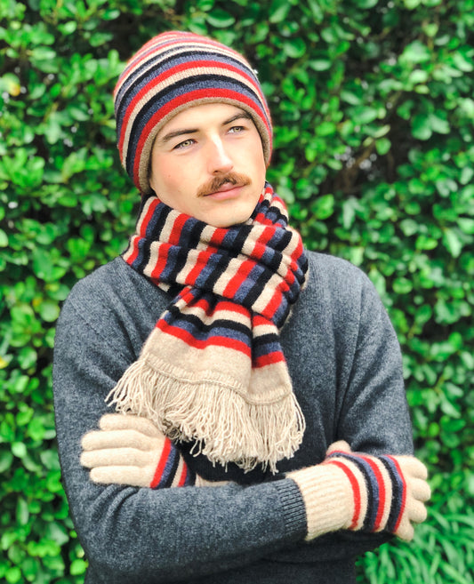 This double thickness multi coloured striped scarf with tassels comes in four different colourways. Made from possum merino it is light, warm and so comfortable to wear. Pair with matching stripe beanie. Made in NZ by Lothlorian.