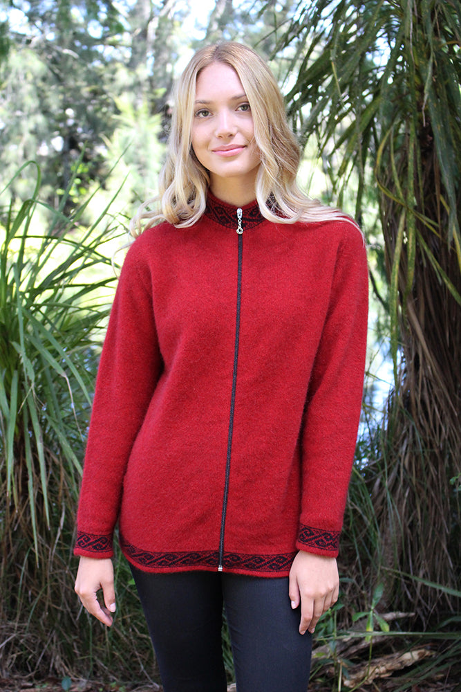 A zip through cardigan with a motif pattern on collar, cuffs & hem in a contrasting colour.  A possum merino blend available in sizes XS-XXL. Made in NZ by Lothlorian. NOTE: * after colour denotes a custom colour to our store, not always readily available. Red.
