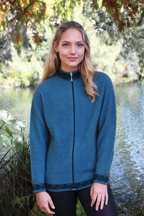 A zip through cardigan with a motif pattern on collar, cuffs & hem in a contrasting colour.  A possum merino blend available in sizes XS-XXL. Made in NZ by Lothlorian. NOTE: * after colour denotes a custom colour to our store, not always readily available. Teal.
