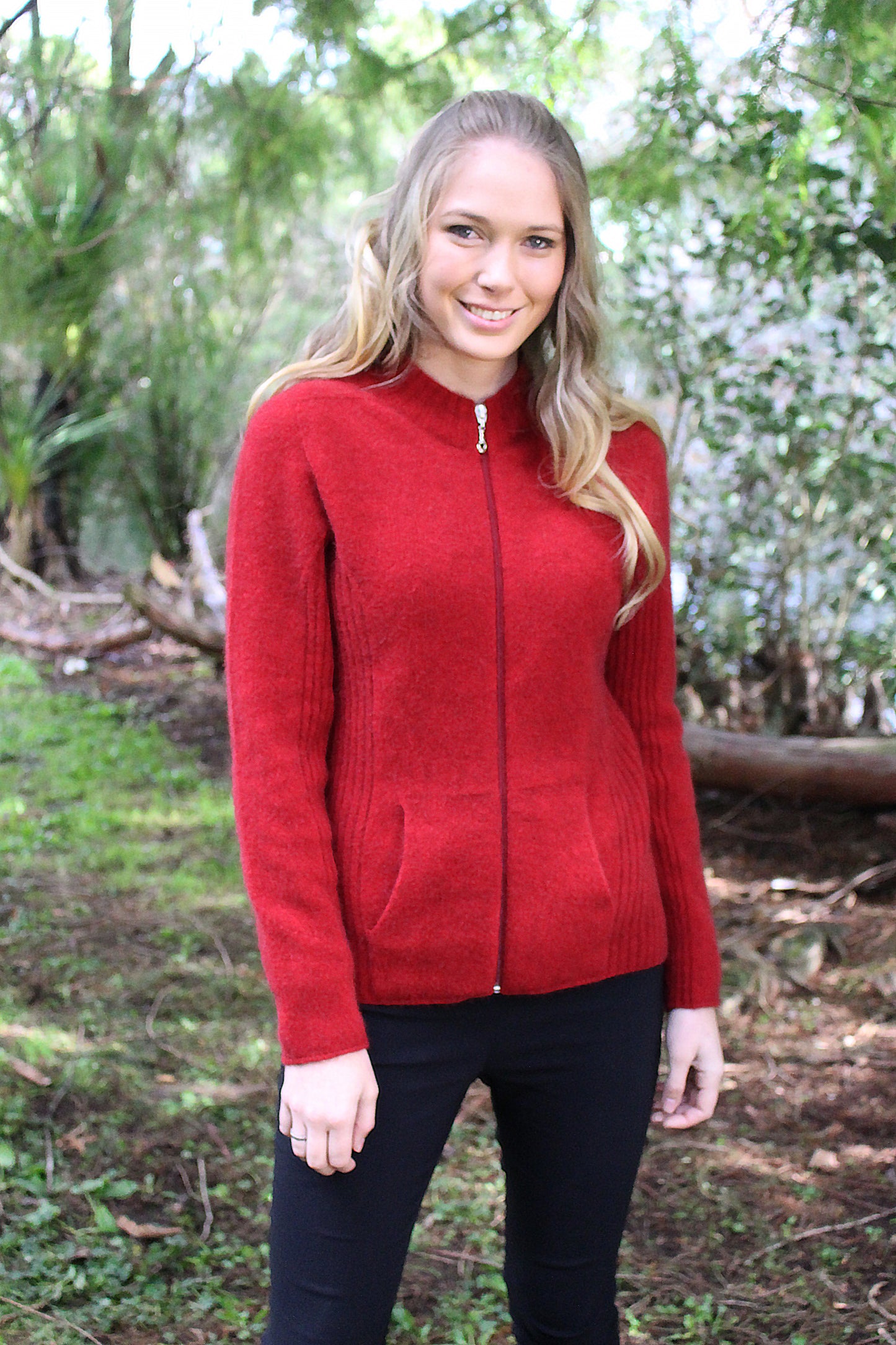 A flattering but practical style jacket. Rib details on the side panels add a little shape, has a full zip and seamless pockets. Available in sizes XS, S, M, L, XL, XXL. Made in NZ from a possum merino blend by Lothlorian. Red.