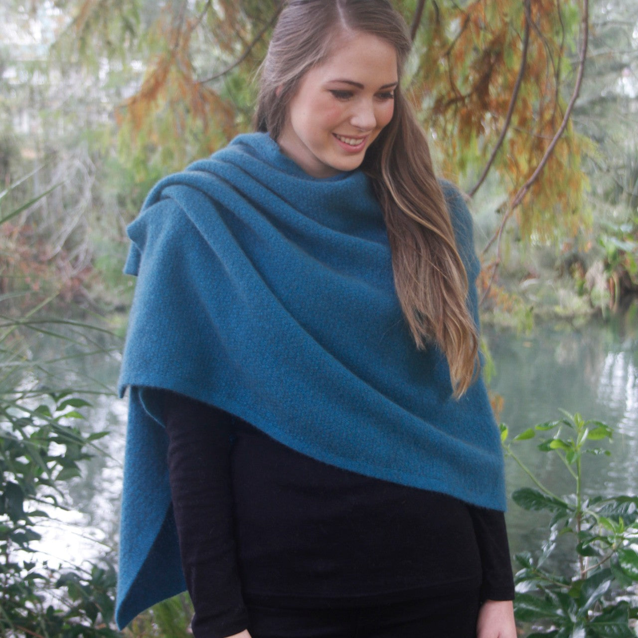 A beautiful textured wrap that can be worn several ways - as a poncho with the zip over the shoulder, zip to the front like a cape, as a wrap or scarf and if you feel a bit daring, a skirt! Available in 12 colourways. Made in NZ by Lothlorian. Teal.