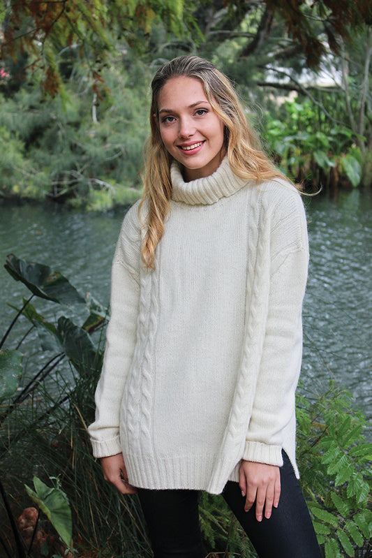 This gorgeous chunky cabled jumper is a very relaxed style. With the longer length it is perfect for wearing over fitted jeans or leggings. Made from the finest alpaca fleece it is available in natural and a delicate shade of rose. Total Luxury!! In sizes S through to XL. Made in NZ by Lothlorian. Natural.