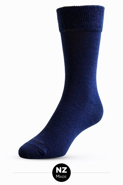 A fine knit Merino Wool dress sock with a new improved cuff for comfortable wear. NZ Sock Co have swapped out the traditional 1 x1 elasticated rib cuff and replaced it with a high stretch, double layer cuff for soft, non-restrictive comfort. Comes in a 2 pair pack. Made in Ashburton, NZ. Navy.