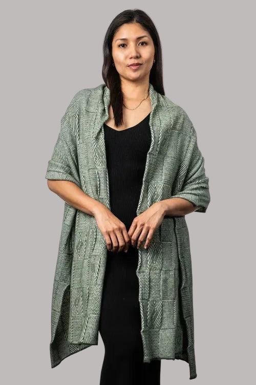 How beautiful is the Jacquard Wrap? A multi-textured design, knitted in two-tone colours with a scallop edge finish. This is the perfect accessory for daytime, a night out or a trip away. Wear it your way to suit your occasion. Luxury at its finest! Approx. 56cm wide x 200cm long. Made by Koru of NZ.