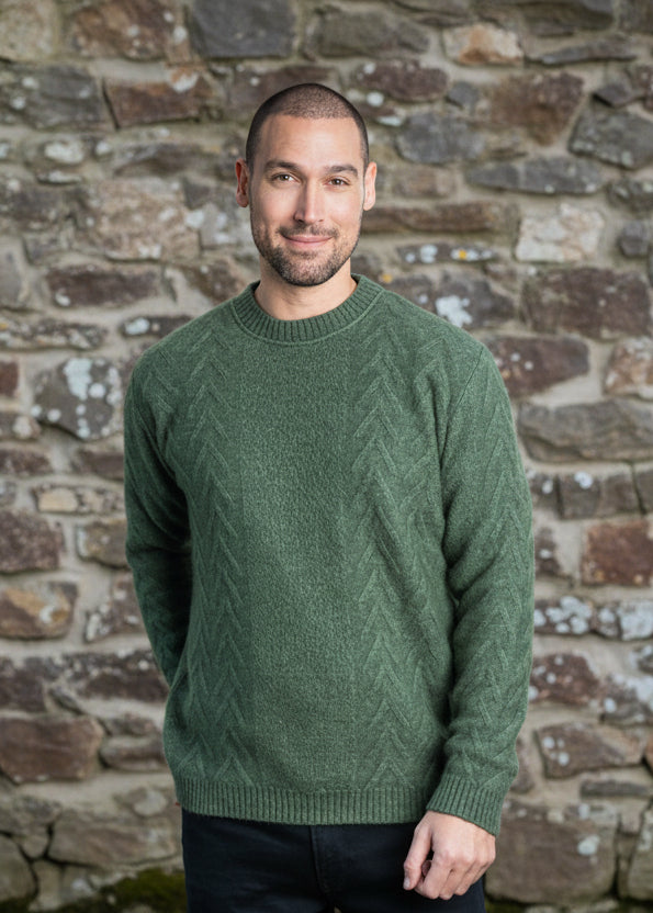 A crew neck style featuring a textured Aran pattern on the front and sleeves with a ribbed crew neckline. Made by Koru Knitwear, NZ.