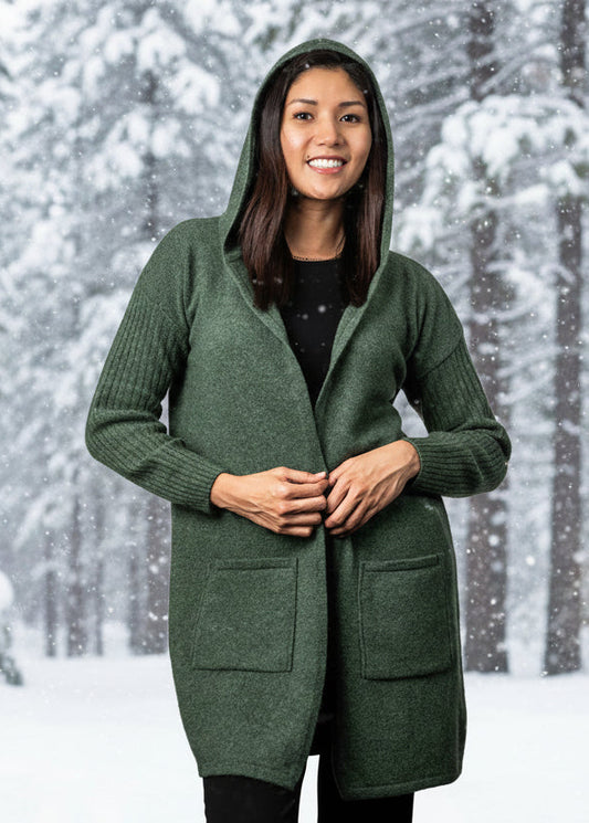 This beautiful classic longline cardigan features ribbed sleeves, patch pockets and hood. Made from a luxurious blend of Possum, Merino and Silk you will want to wear it all winter long! Made in NZ by Koru for their Trilogy Collection.