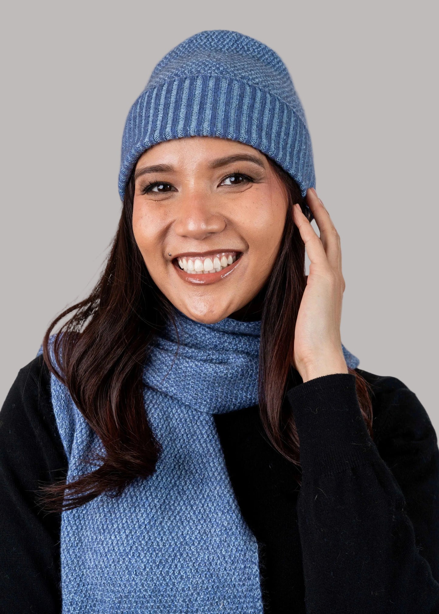 A versatile lightweight beanie knitted in a textured moss stitch pattern. This beanie is created with a yarn plating technique to create a subtle two tone effect. One size only. Made by Koru Knitwear NZ.