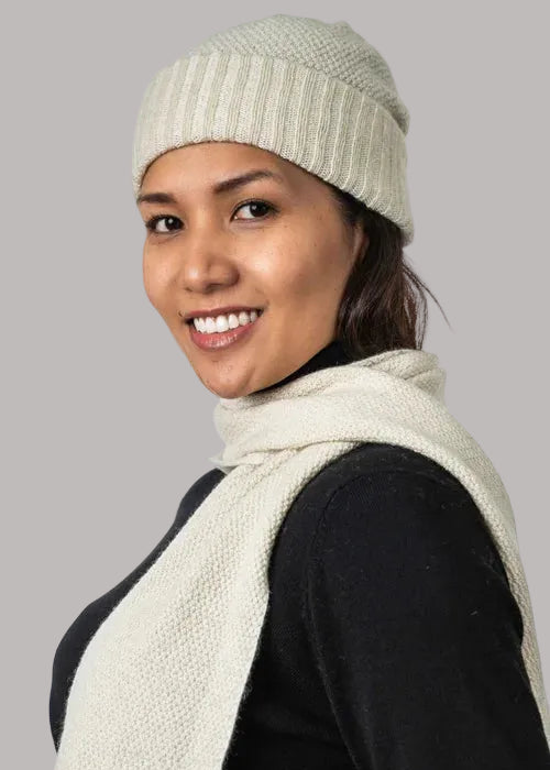 A versatile lightweight beanie knitted in a textured moss stitch pattern. This beanie is created with a yarn plating technique to create a subtle two tone effect. One size only. Made by Koru Knitwear NZ.