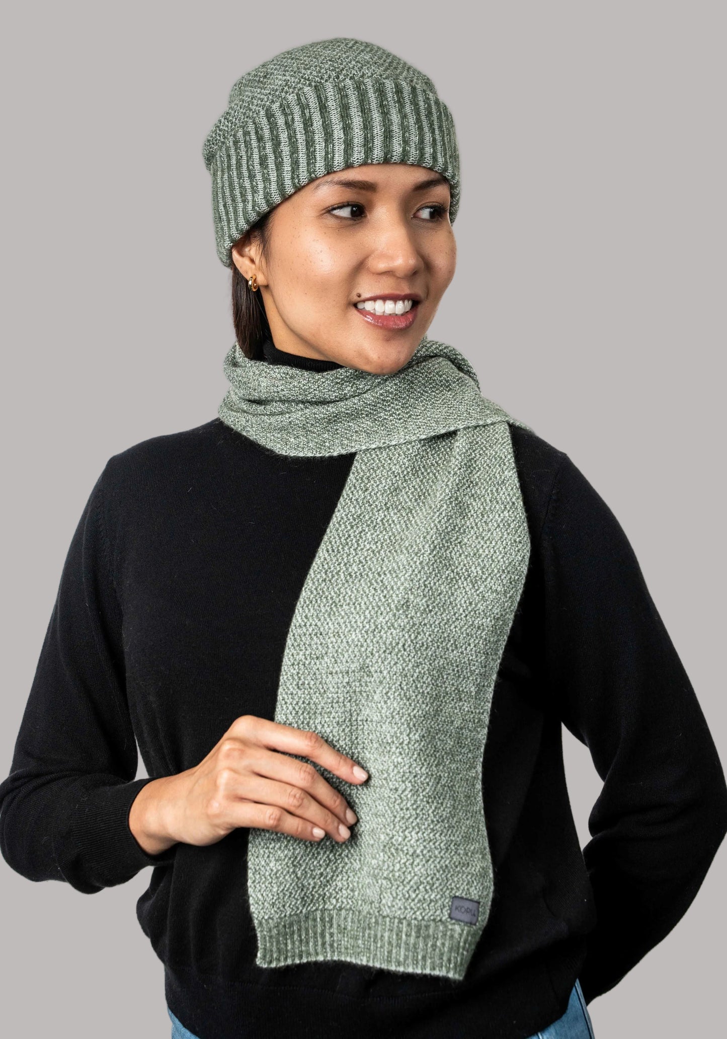 Generous in width and length, this cosy scarf features a two tone textured moss stitch pattern. Made from a blend of possum, merino and silk it is a perfect winter staple. Made by Koru of NZ.