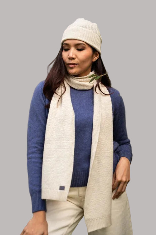 Generous in width and length, this cosy scarf features a two tone textured moss stitch pattern. Made from a blend of possum, merino and silk it is a perfect winter staple. Made by Koru of NZ.