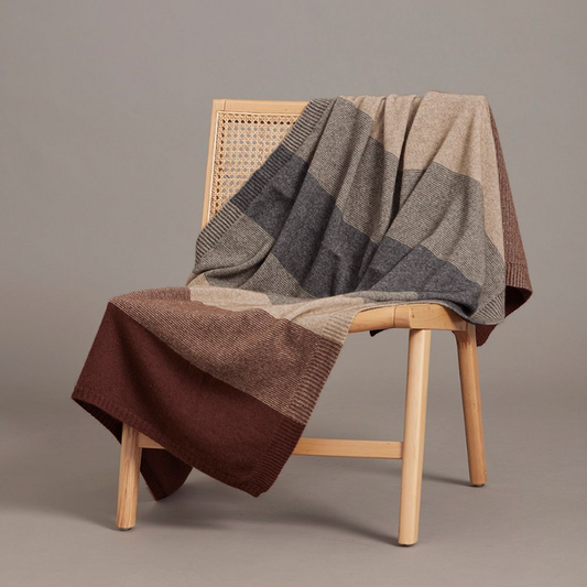 The beautiful Ombre Throw by McDonald is perfect for keeping you warm both at home or when traveling! Great draped over a chair or couch to add a little bit of extra pizazz to any room. Featuring a tonal ombre pattern inspired by our best-selling Ombre Poncho, this Possum Merino throw offers superior warmth, cosiness, and softness. Rust.