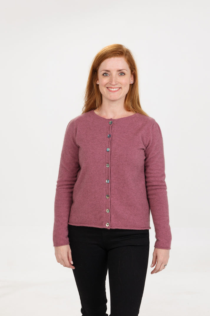 Gorgeous paua shell buttons add a touch of class to this classic semi cropped cardigan. Made from luxurious possum, merino & silk makes this so beautiful to wear. Made in NZ by Native World. Sizes S - 2XL. Magnolia.