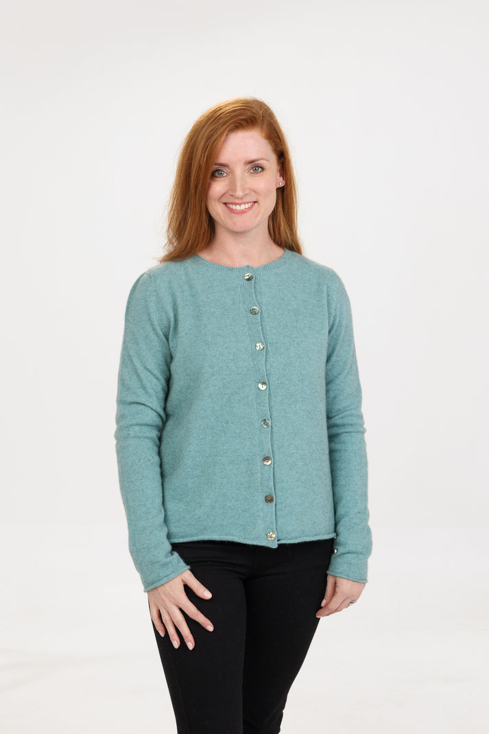 Gorgeous paua shell buttons add a touch of class to this classic semi cropped cardigan. Made from luxurious possum, merino & silk makes this so beautiful to wear. Made in NZ by Native World. Sizes S - 2XL. Topaz.