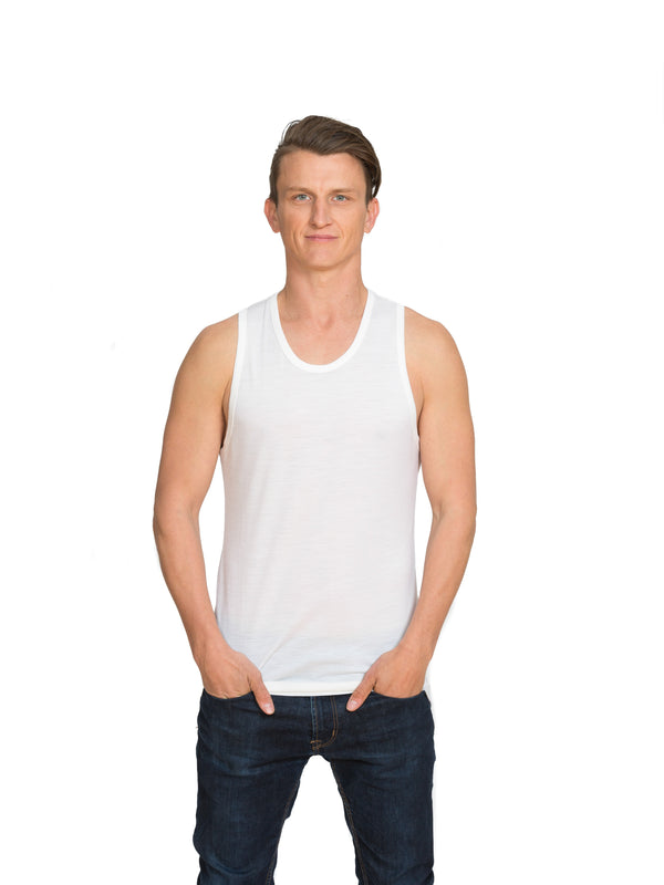 Designed with a lower round neck this merino singlet is discreet under any top in black or ivory white. Tuck in the shaped tail at the back for extra warmth. This is a slim fit base layer. Sizes S - 3XL. Proudly made in NZ. White.