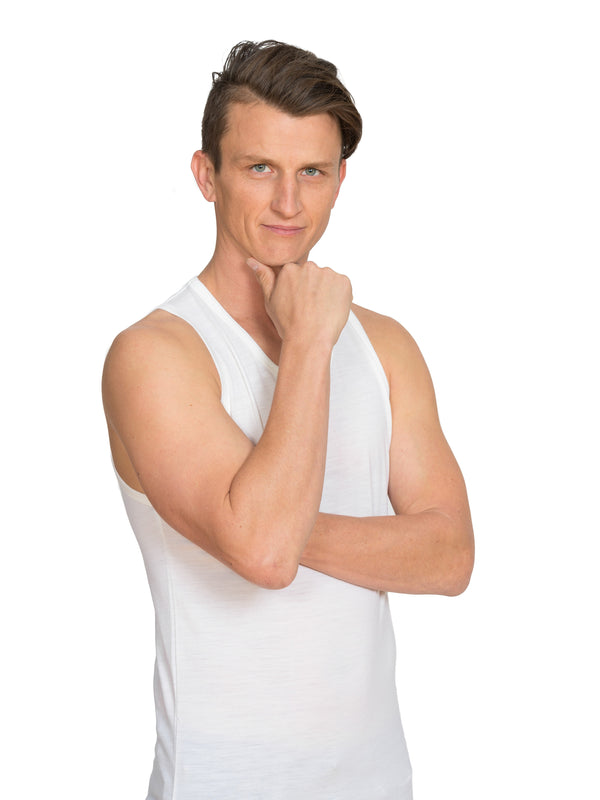 Designed with a lower round neck this merino singlet is discreet under any top in black or ivory white. Tuck in the shaped tail at the back for extra warmth. This is a slim fit base layer. Sizes S - 3XL. Proudly made in NZ. White.