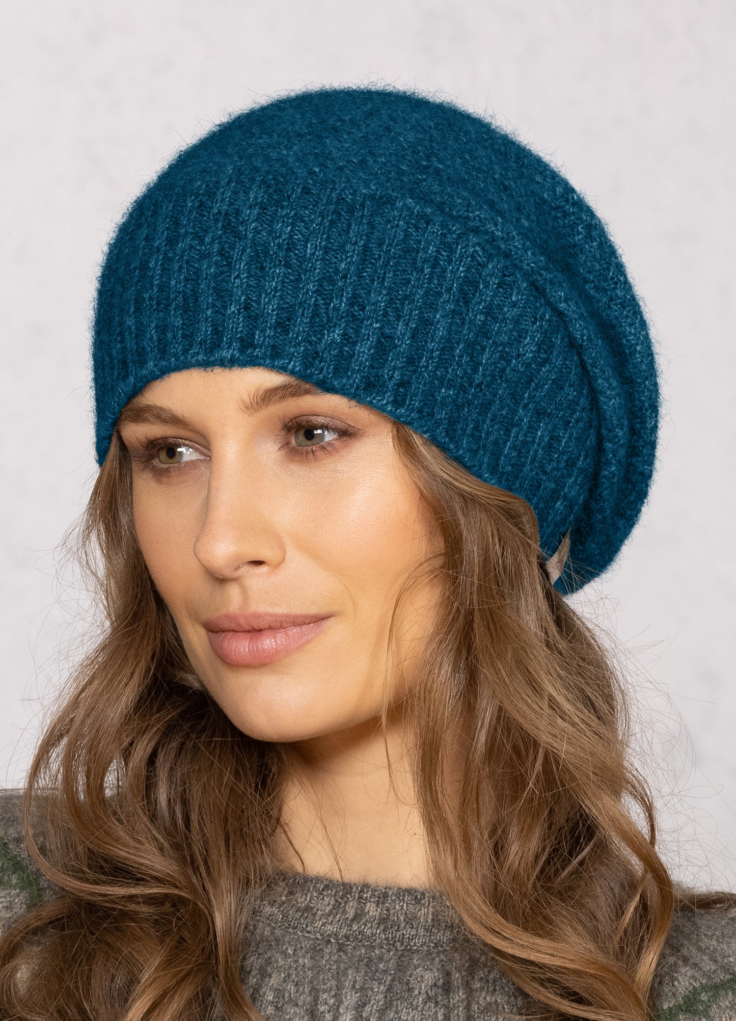 This fashion baggie beanie is knitted in a moss stitch with a rib band that can be worn as is or folded back. Made from a blend of possum merino and available in one size only. Made in Christchurch, NZ by Noble Wilde. 