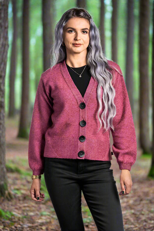 A modern twist on a V neck cardigan. This style is hip length and features oversize two tone buttons and a wide rib detail on the hem. In the beautiful new Koru shade of Moss. Includes a spare button. Made in NZ by Koru.