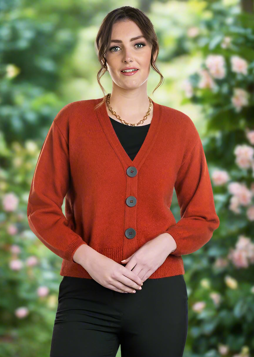 A modern twist on a V neck cardigan. This style is hip length and features oversize two tone buttons and a wide rib detail on the hem. In the beautiful new Koru shade of Moss. Includes a spare button. Made in NZ by Koru.