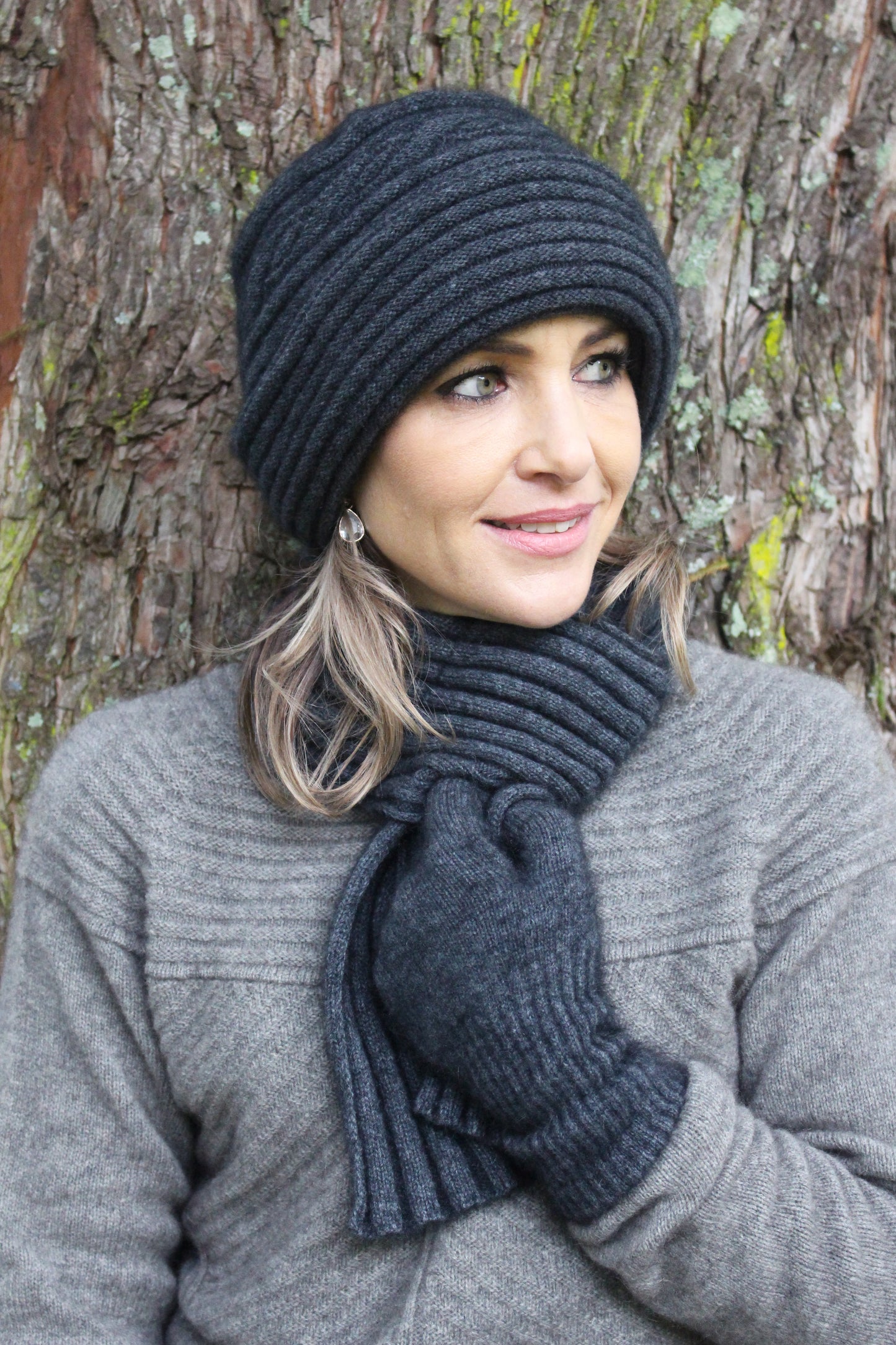 A luxurious double thickness hat with cable detail. A blend of possum merino in one size only. Made in NZ by Lothlorian for their Zinity Collection. Charcoal.