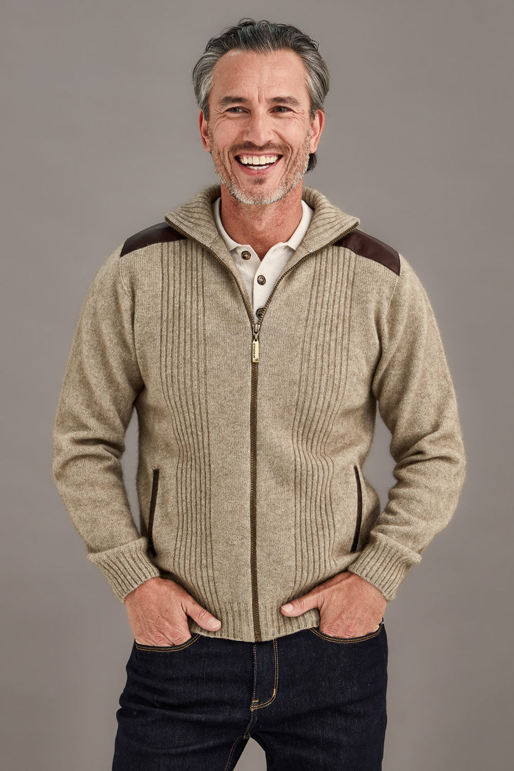 This very sharp looking zip up jacket features genuine lambskin trim on the shoulders and pockets. The turn back collar and front panels have a rib pattern adding more style. Made from natural fibres of Possum Merino and Mulberry silk and in a winter weight it will keep you so warm. The lambskin shoulder and pocket trim are washable. Made by McDonald of NZ.