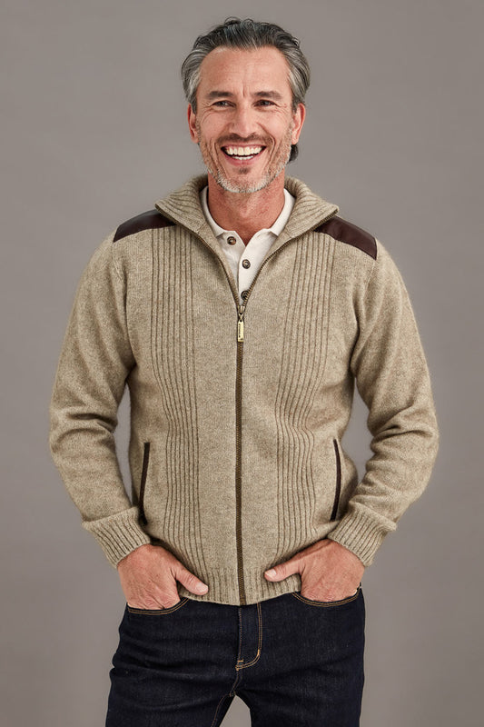 This very sharp looking zip up jacket features genuine lambskin trim on the shoulders and pockets. The turn back collar and front panels have a rib pattern adding more style. Made from natural fibres of Possum Merino and Mulberry silk and in a winter weight it will keep you so warm. The lambskin shoulder and pocket trim are washable. Made by McDonald of NZ.